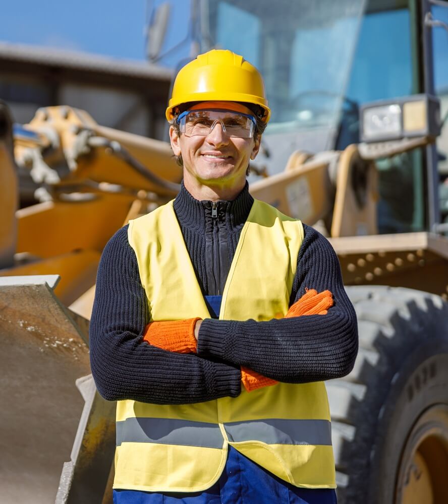cheerful-male-worker-standing-near-tractor-at-fact-2024-10-18-08-08-15.jpg